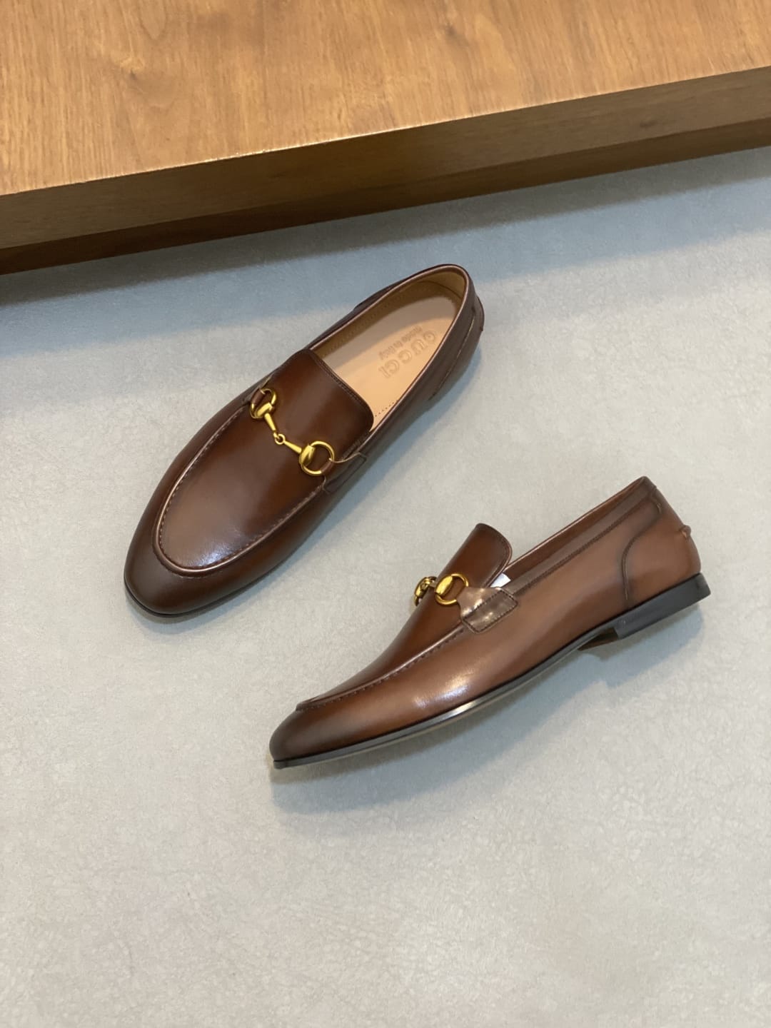 GUCCI Brown leather loafer is designed with an elongated for MEN