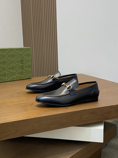 GUCCI Black leather loafer is designed with an elongated for MEN